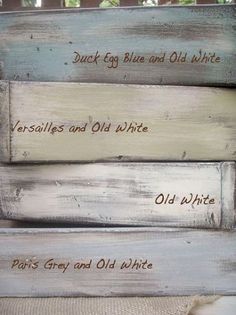 some old white painted wooden boards with words on them