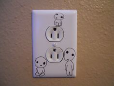 an electrical outlet with three little stick figures on it's cover and one light switch