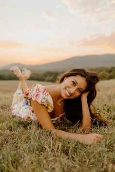 a beautiful young woman laying on the grass