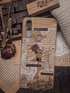 an old book is laying on the table next to a keyboard and some paper with writing