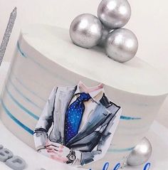 a birthday cake decorated with an image of a man in a suit and tie on it