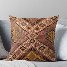 a decorative pillow sitting on top of a couch