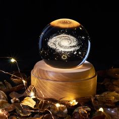 a snow globe sitting on top of a wooden stand