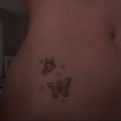 a woman's stomach with two butterflies on it