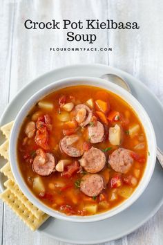 a bowl of crock pot kielbasa soup with crackers on the side