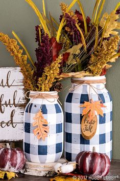 two blue and white jars with fall decorations