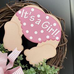 it's a girl door hanger in front of a wreath