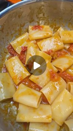 a pan filled with pasta and sauce on top of a stove