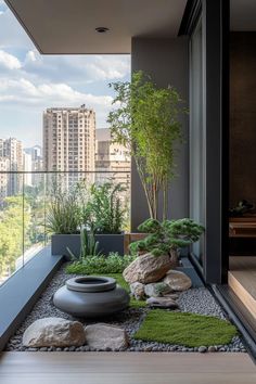 an outdoor area with rocks, grass and plants on the ground in front of a large window