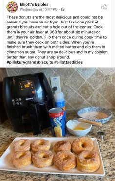 donuts on a plate next to an air fryer and other ingredients for making doughnuts