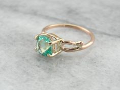 This is a beautiful vintage engagement ring, a solitaire that is as lovely as it is versatile! Simple sweeps of gold grace the shoulders, providing a perfect balance to the gorgeous center stone. We've set a Colombian emerald in this ring, a bright green gem with unbelievable shine! Incredibly clear and filled with light, this emerald is of exceptional quality, a one of a kind stone from our collection of Colombian gems that we're proud to offer! Metal: 14K Yellow and Rose Gold Gem: Emerald 1.56 Emerald Gold Engagement Ring, Beautiful Engagement Rings Vintage, Emerald Solitaire Ring, Columbian Emeralds, Beautiful Rings Vintage, Green Gem, Cushion Cut Ring, Colombian Emeralds, May Birthstone