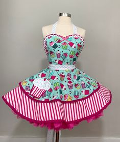 a mannequin wearing a dress with cupcakes on it