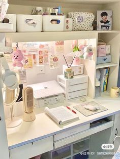 a white desk topped with lots of drawers under a shelf filled with books and other items