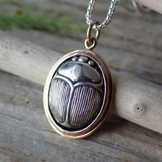 Embark on a journey into the mystique of ancient Egypt with this meticulously crafted pendant, thoughtfully designed to capture the essence of the revered scarab beetle. Expertly fashioned from sterling silver, each piece reflects our commitment to both artistry and enduring quality. Measuring 23mm in length and 14mm in width, this charm encapsulates the intricate details of the scarab beetle, from its distinctive form to its finely etched features. The scarab's symbolism as a representation of Scarab Beetle Jewelry, Beetle Jewelry, Tortoise Beetle, Scarab Beetle, Wax Carving, Old Jewelry, Amulets, Recycled Silver, Vintage Cat