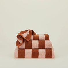 two towels folded on top of each other in brown and white checkerboard pattern