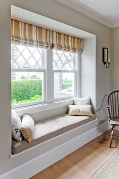 a window seat in the corner of a room