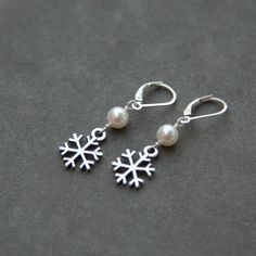 "Sterling Silver and Swarovski pearl snowflake earrings, perfect for the holiday season or a winter wedding. These earrings measure just over 1 1/2\" or 38mm in total length and are made in all Sterling Silver and Swarovski pearls. The third photo shows the pearl colors available, please let me know if you'd like larger photos of any colors. The last two photos show the coordinating bracelet and necklace which are available in my shop here: http://www.etsy.com/shop/SprigJewelry/search?search_que Winter Bridesmaid, Winter Bridesmaids, February Birthstone Necklace, Snowflake Earrings, Earrings Christmas, Mom Jewelry, Wedding Jewelry Earrings, Holiday Jewelry, Swarovski Pearls