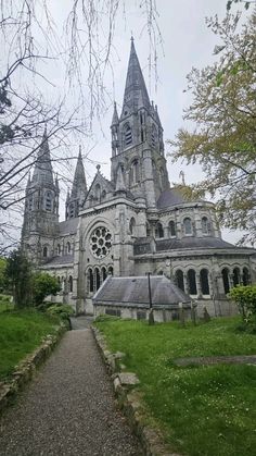 an old church with two towers and a walkway leading up to it