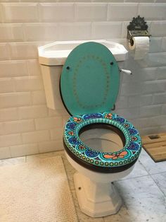 a toilet with a colorful seat cover in a bathroom