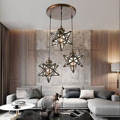 a living room filled with lots of furniture next to a wall mounted light hanging from the ceiling