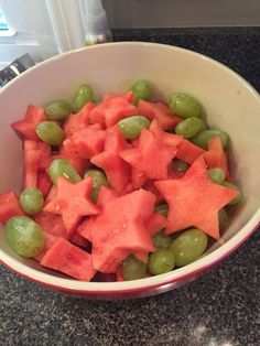 a bowl filled with watermelon and grapes