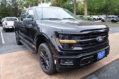 a black truck parked in a parking lot