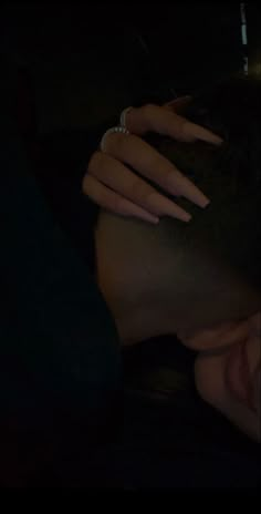 a close up of a person's face with their hands on her head