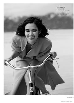 a woman riding on the back of a bike