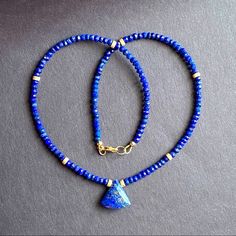 Beaded Choker Necklace Beaded With 3.5mm Genuine Blue Lapis Lazuli Hand Faceted Natural Stone, Accented With Stardust 14k Gold Filled Spacers. And Centered With Lapis Lazuli Pendant * Gemstone : Lapis Lazuli * Metal : All Metal Used Is 14k Gold Filled * Closure : Lobster Clasp * Size: 16” Inches Xmas Christmas Gift Beaded Necklace Blue, Blue Stone Necklace, Lapis Jewelry, Beaded Collar Necklace, Lapis Pendant, Long Tassel Necklace, Lapis Necklace, Lapis Lazuli Pendant, Lapis Lazuli Necklace