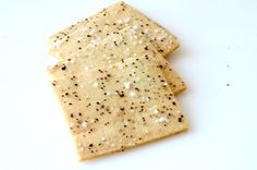 two crackers sitting on top of a white table next to each other with black and white sprinkles