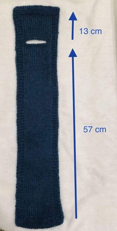 an image of a blue knitted arm warmer with measurements for the size and length