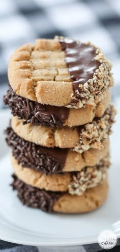 a stack of cookies with chocolate frosting and sprinkles