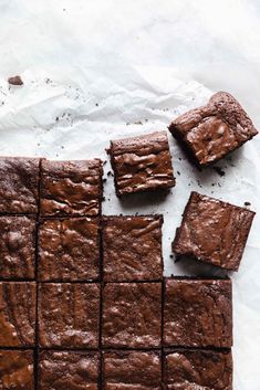 chocolate brownies cut into squares on top of paper