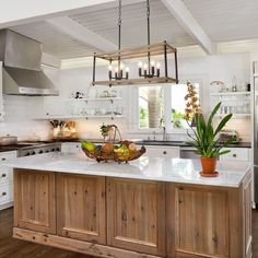 a large kitchen with an island in the middle