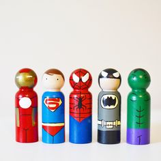 a group of wooden toy figurines sitting next to each other