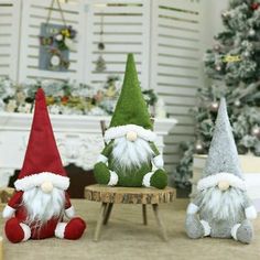 three christmas gnomes sitting next to each other