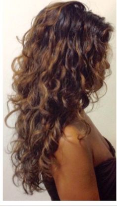 the back of a woman's head with long curly hair and curls on it