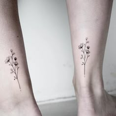 two small tattoos on the legs of people with flowers in them, one is black and white