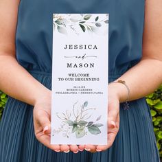 a person holding up a wedding program in front of some plants and bushes with the words, mason welcome to our beginning