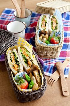 two baskets filled with food sitting on top of a table next to utensils