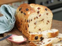 a loaf of bread sitting on top of a wooden cutting board