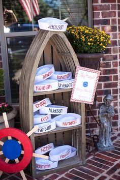 a display in front of a brick building filled with pots and baskets full of items