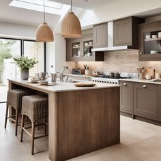 a kitchen filled with lots of counter top space next to a dining room table and chairs