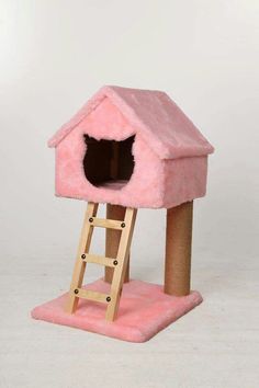 a pink cat house with a ladder to the top