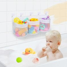 a baby sitting in a bathtub with toys