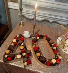 the number forty is made out of chocolates and strawberries on top of a table