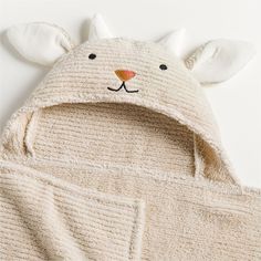 a white teddy bear hoodie with ears on it's head and eyes open