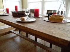 a wooden table topped with plates filled with food