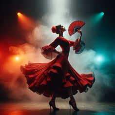 a woman in a red dress is holding an umbrella and standing on stage with lights behind her