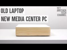 an old laptop is sitting on top of a white table with the words new media center pc